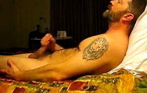 Hairy bear jacking on bed
