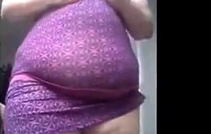 SSBBW in a purple dress plays with her giant belly
